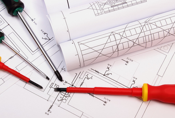 Rolls of diagrams and work tools on electrical construction drawing of house - Photo, Image