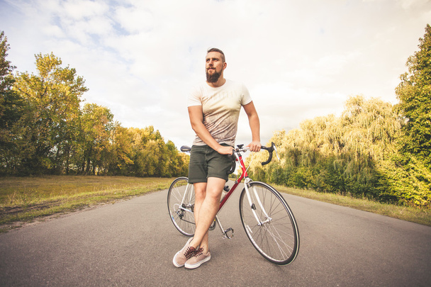 Jeune homme de style hipster posant avec vélo
 - Photo, image