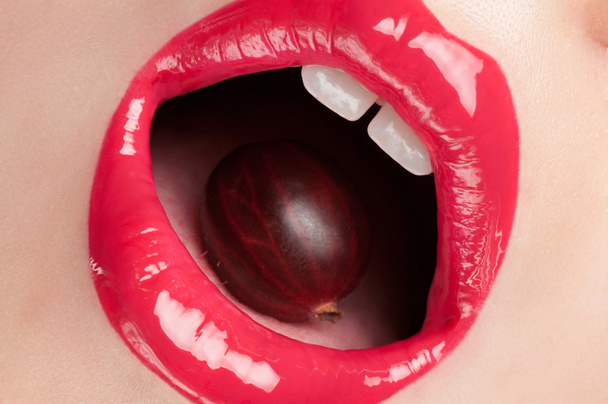 Red lips with a cherry. - Φωτογραφία, εικόνα