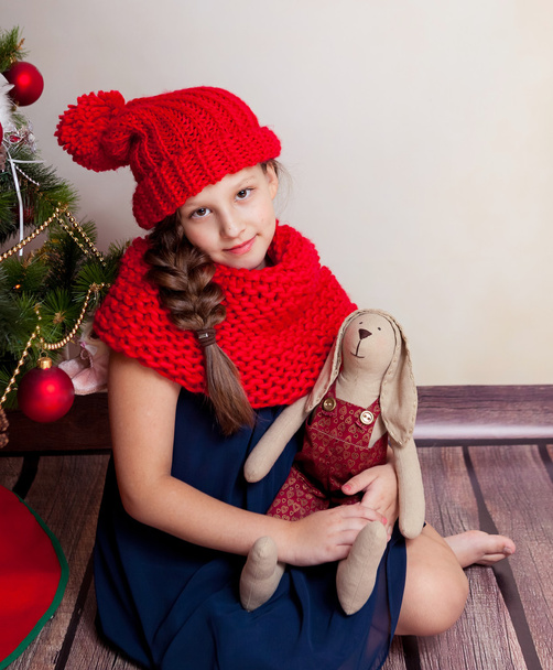 Girl holding big textile hare - Фото, зображення