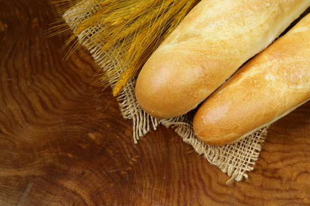 fresh French baguette (bread) on wooden background - Photo, Image
