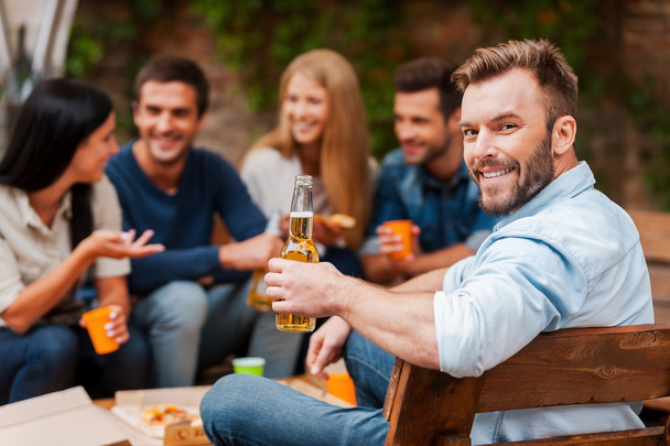man holding bottle with beer with friends - Photo, image