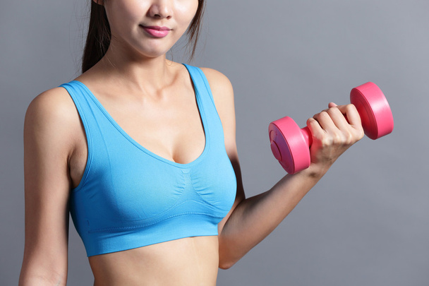 Sporty  woman  lifting weight - 写真・画像