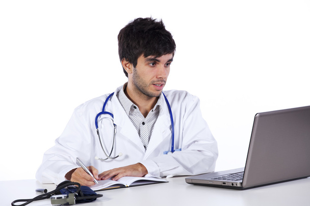 Frendly young doctor working with his laptop - Photo, Image