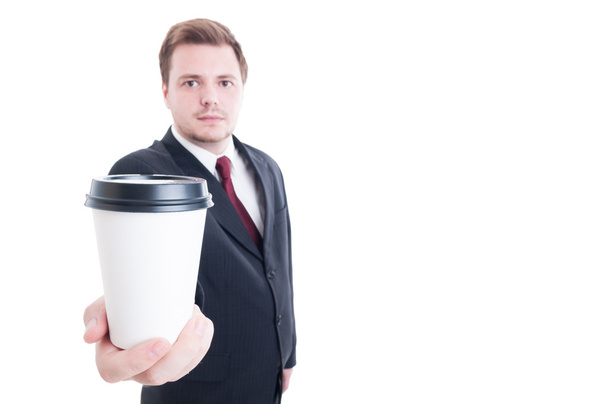 Businessman holds and offer a coffee to go cup - Foto, imagen