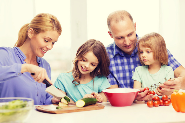 happy family with two kids making dinner at home - Foto, Imagen