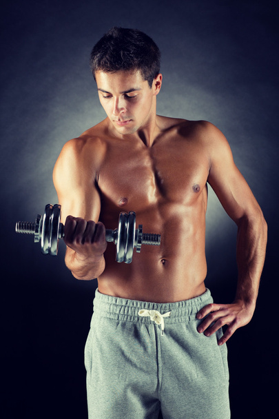 young man with dumbbell - Photo, Image