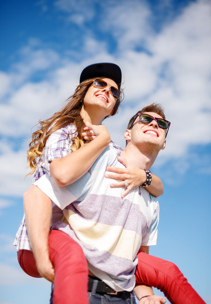 smiling teenagers in sunglasses having fun outside - Fotografie, Obrázek