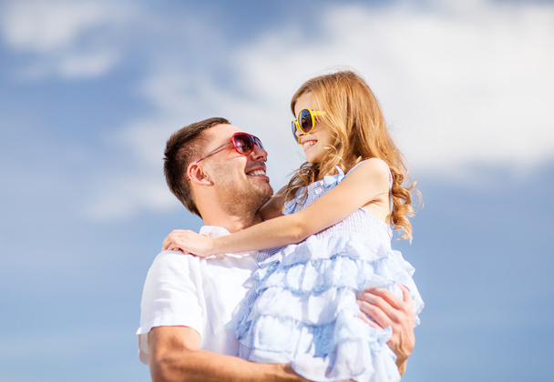 happy father and child in sunglasses over blue sky - Fotó, kép