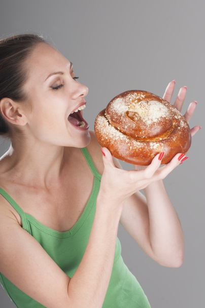 Young girl biting a loaf of freshly baked - Photo, image