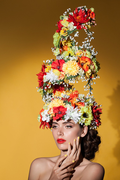 Beauty portrait closeup of young beautiful white woman with big bouquet of flowers on her head. - Foto, immagini