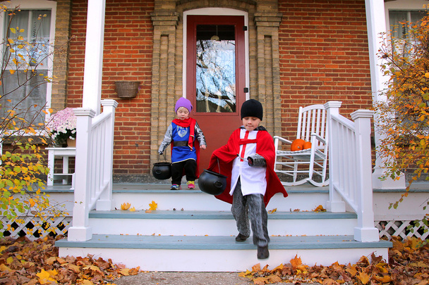 Children in Costumes Trick-or-Treating on Halloween - Photo, Image