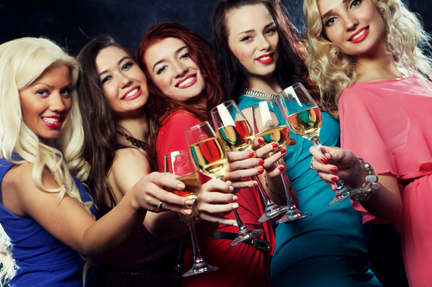 partying girls clinking flutes with sparkling wine - 写真・画像