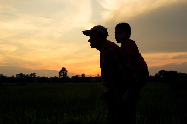 Silhouette, Dad took his son piggyback - Photo, Image