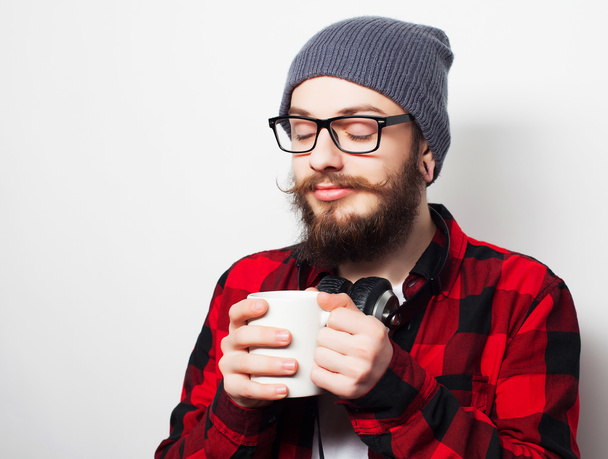 young bearded man with a cup of coffee - Fotó, kép