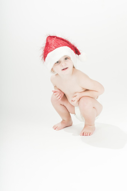 Adorável bebê criança menina vestindo chapéu de Papai Noel e fraldas
 - Foto, Imagem