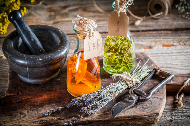 Homemade tincture in bottles with alcohol and herbs - Fotó, kép