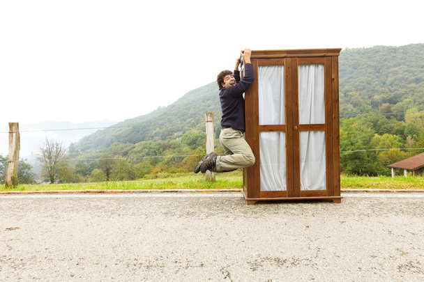 man moves wardrobe, is making a move - 写真・画像