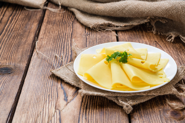 Sliced Cheese on wooden background - Foto, afbeelding