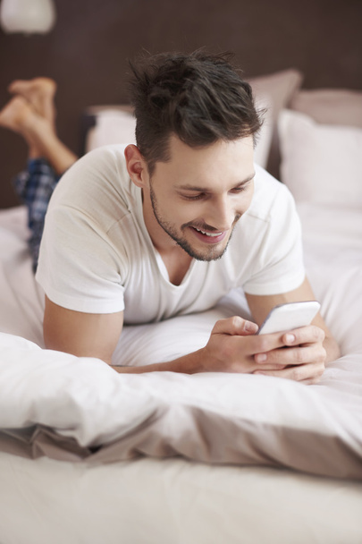 Cheerful man texting with someone funny - Photo, Image