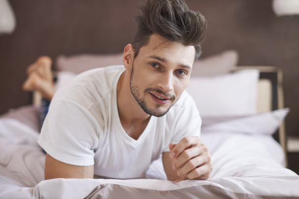 Man relaxing at his bed - Photo, Image