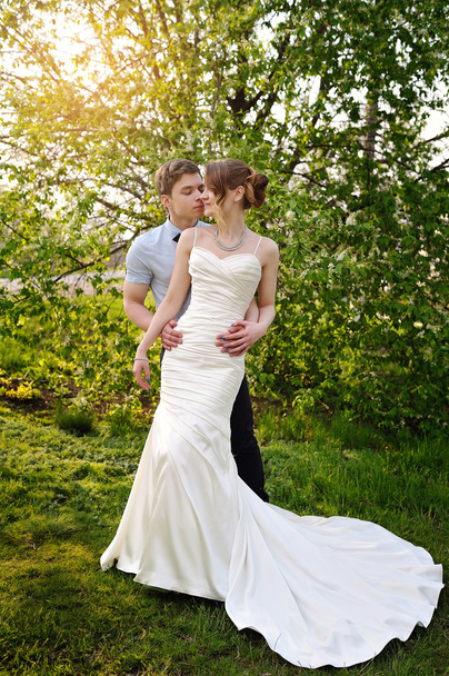 Bride and groom at wedding Day walking Outdoors on spring nature - Photo, Image