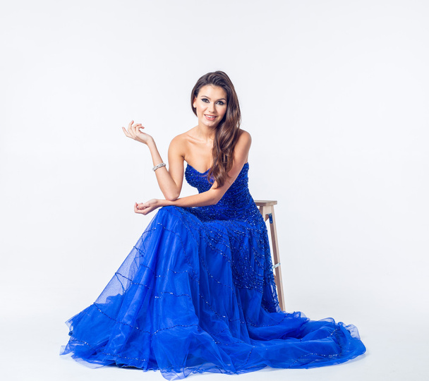 beautiful young slim brunette woman wearing a blue dress - Fotografie, Obrázek