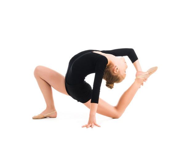 little gymnast stretching on the floor - Фото, изображение