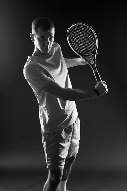 Tennis player on black background. Studio shot - Zdjęcie, obraz