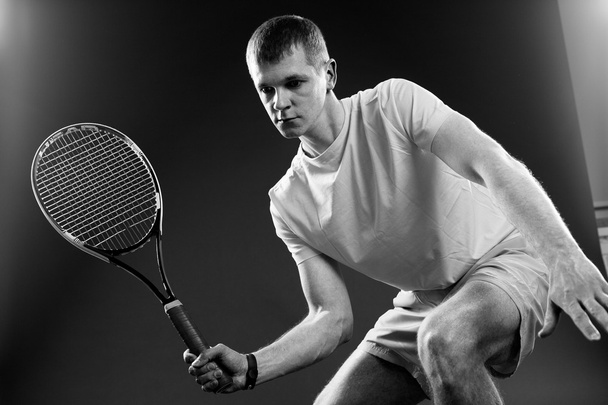 Tennis player on black background. Studio shot - Fotó, kép