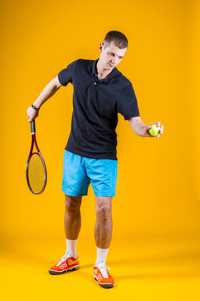 Tennis player on yellow background. Studio shot - Фото, изображение