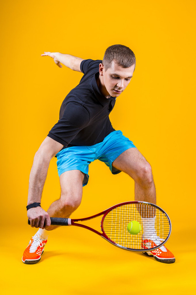 Tennis player on yellow background. Studio shot - Foto, immagini