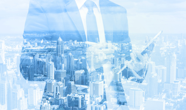 Double exposure of businessman with cityscape - Photo, Image