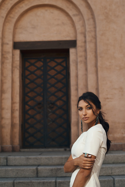 lady in dress against ancient building with thoughtful look - 写真・画像
