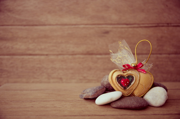 Souvenir golden Heart on the stone with wood background,Valentin - Photo, Image