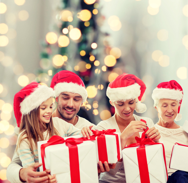 happy family in santa hats with gifts - Photo, image