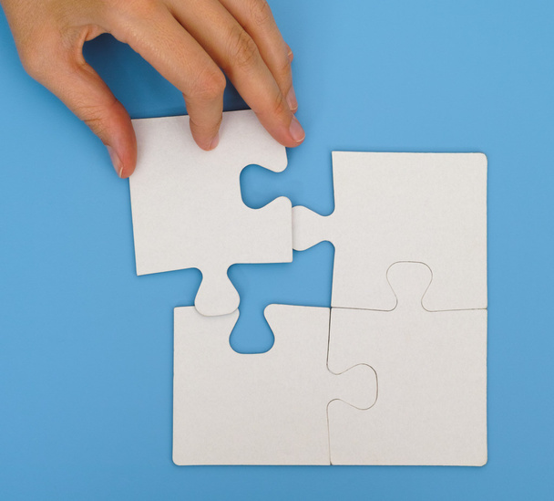 Woman hand putting final piece of puzzle - Photo, Image