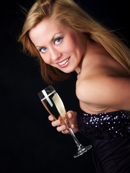 Young woman with champagne over dark background - Photo, Image