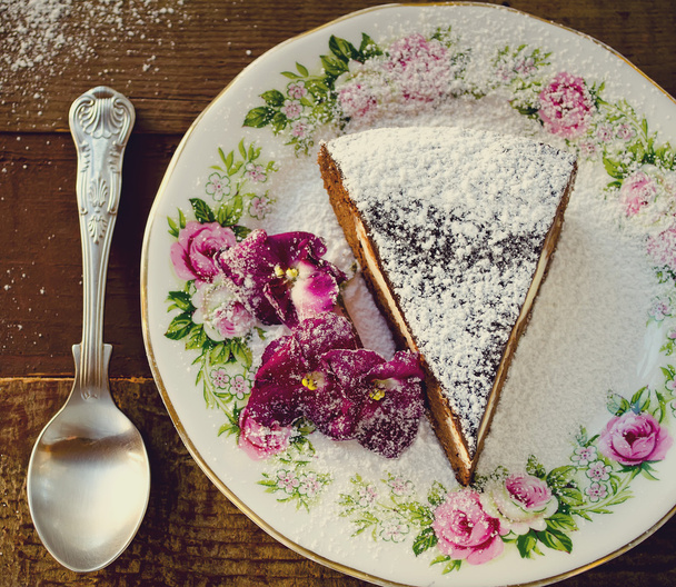 Homemade chocolate cake with cream cheese, walnuts and flowers - 写真・画像