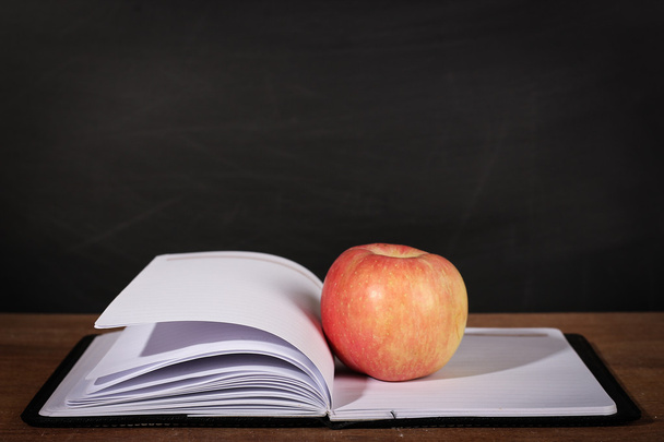 Apple and Opened Book with Blackboard Background - Foto, Bild