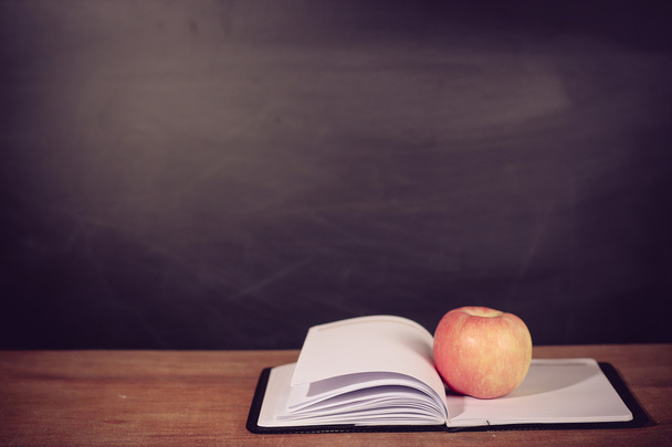 Apple and Opened Book with Blackboard Background - Foto, imagen