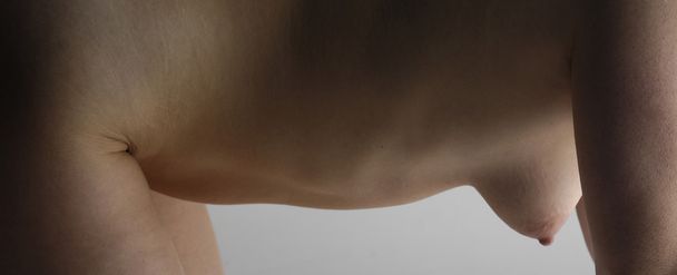 Nude woman with back pain - Zdjęcie, obraz