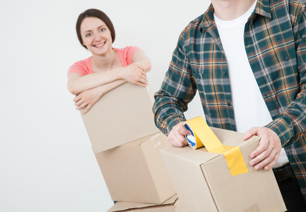 couple packing things in cardboard boxes - Photo, Image