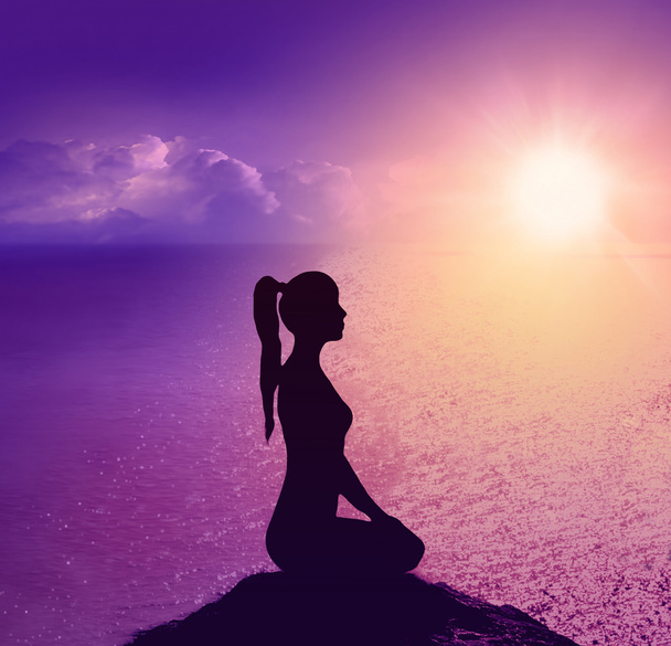 Silhouette of a woman on the beach. Yoga and meditation. - Photo, Image