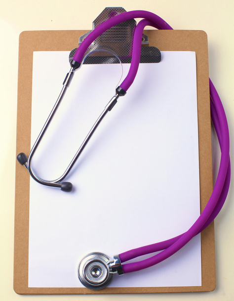 Medical stethoscope and a plate on the table - Photo, Image