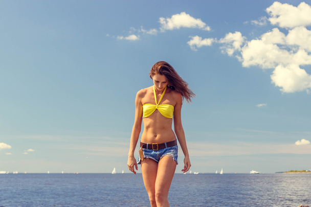 Beautiful woman in bikini posing near the sea - Zdjęcie, obraz