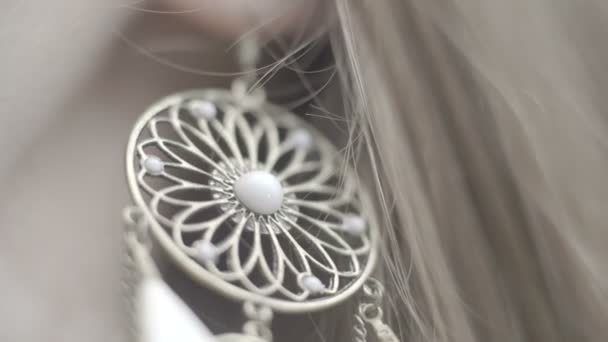 Beauty girl Earrings with white feathers extra close up - Footage, Video