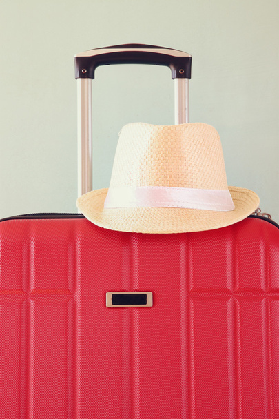 image of red elegant travel luggage and fedora hat. - Фото, зображення