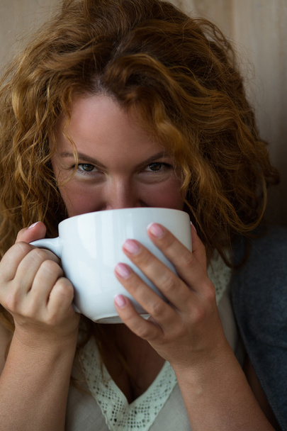 Portrait of pretty mature woman drinking tea - Zdjęcie, obraz