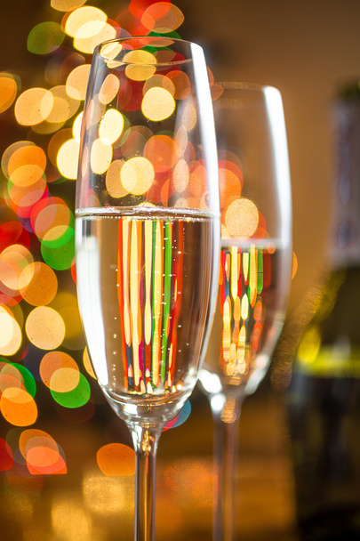 two glasses with champagne against sparkling Christmas tree - Photo, Image